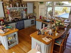 a kitchen filled with lots of counter top space and wooden flooring next to an open window