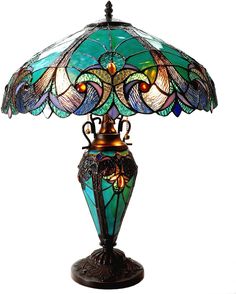 a stained glass lamp on a stand with an ornate design and gold trimmings