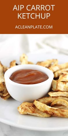 an air carrot ketchup in a white bowl on a plate with grilled french fries