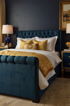 a bedroom with blue walls and gold accents