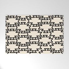 an abstract black and white pattern on a wall in a room with light colored walls