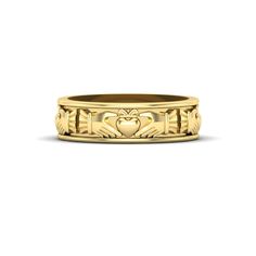 a yellow gold wedding band with an intricate heart design on the front and sides, set in