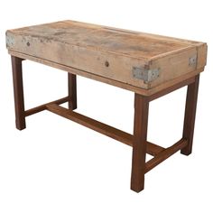 an old wooden table with two drawers on it