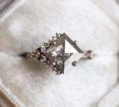 a diamond ring sitting on top of a white cloth