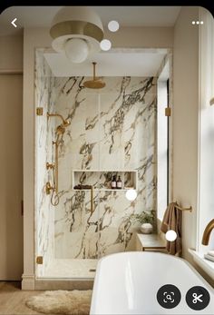 the bathroom is decorated in marble and gold