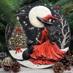 a christmas ornament with a woman in a red dress and witch hat on it