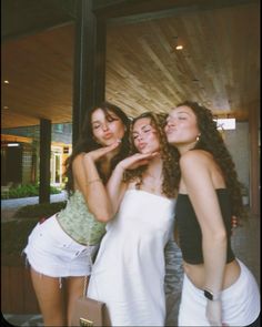 three young women posing for a photo together