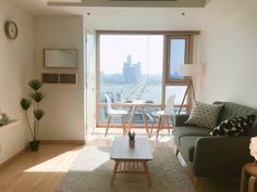 a living room filled with furniture and a flat screen tv mounted to the side of a wall