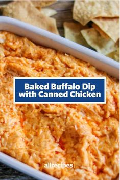 baked buffalo dip with canned chicken in a white dish next to tortilla chips