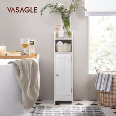 a bathroom with a white cabinet next to a window