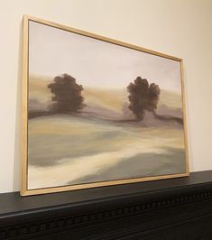 a painting is hanging on the wall above a fireplace