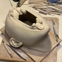 a clay sculpture is being made on a table