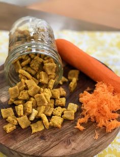 carrots and dog food on a wooden cutting board