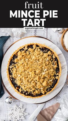 a close up of a pie on a plate with the words, fruit mince pie tart