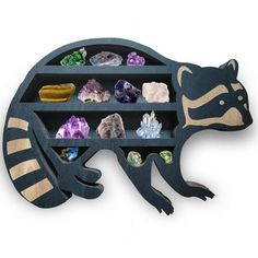 a raccoon shaped shelf with crystals and rocks in it