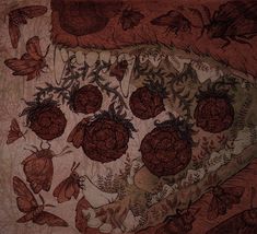 an intricately designed piece of cloth with moths and flowers on it's surface