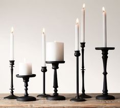 five candles are lined up on a table