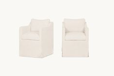 two white chairs sitting next to each other