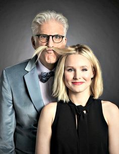 an older man and young woman with fake mustaches on their heads are posing for a photo