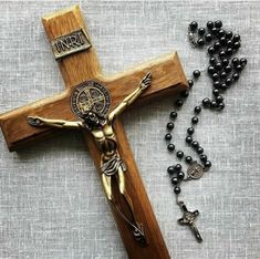 a wooden cross and rosary on a table