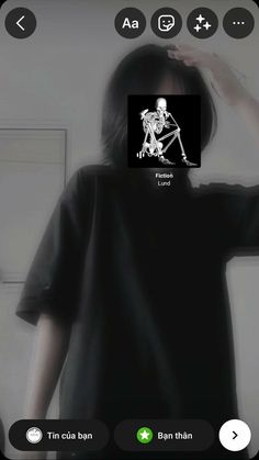 a person wearing a black shirt with a skeleton on it