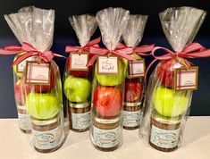 apples, strawberries and bananas wrapped in cellophane with red ribbon on display