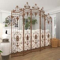 an ornate iron bed frame in a bedroom