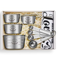 an assortment of measuring cups and spoons in a box