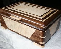 a wooden box sitting on top of a bed