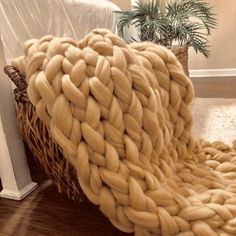 a large woven blanket sitting on top of a wooden floor