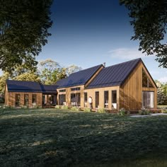 a large wooden house sitting on top of a lush green field