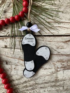 a black and white ornament hanging from a christmas tree