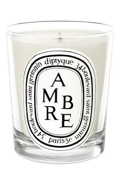 a glass candle with an ambre label on it