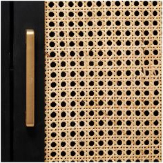 a close up view of a door handle on a rattan surface with holes in it