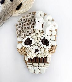 there is a skull made out of marshmallows and other things on the table