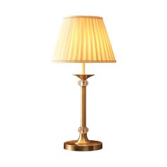 a gold lamp with a white shade on it's base and a light bulb in the middle