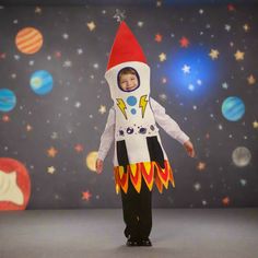 a little boy dressed in a space suit