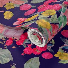 a purple floral wallpaper with pink, yellow and red flowers on the bottom half of it