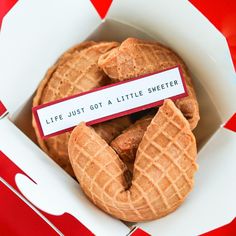 a box filled with waffles sitting on top of a red and white table