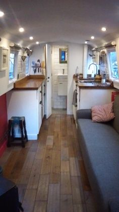 the inside of a tiny home with wood floors