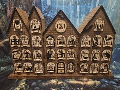 a paper model of a house with many windows and people on the front, inside and out