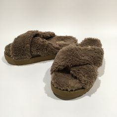 Authentic UGG Fuzz Sugar Cross Slide Women’s Sandals -Color: Hickory -Model: 1120860 -Size: US 11 / UK 9 -New without original box. DETAILS: -Featuring plant-based, repurposed, and low-impact materials with offsets for the small amount of emissions they create (making the materials carbon neutral), our Fuzz Sugar adapts the iconic look and feel of UGG. Using 50% repurposed wool and 50% TENCEL Lyocell sourced from responsibly-harvested trees, our curly UGGplush wool blend offers a soft and textur Slides Women, Carbon Neutral, Slipper Sandals, Womens Uggs, New Color, Plant Based, Wool Blend, Original Box, Slippers