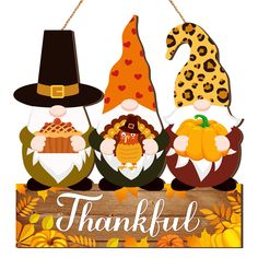 a wooden sign with thanksgiving decorations hanging from it's sides