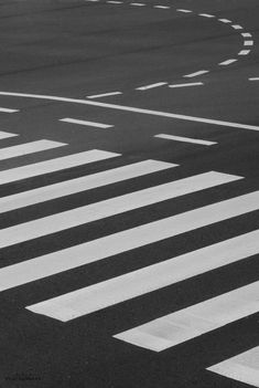 a person riding a skateboard across a cross walk