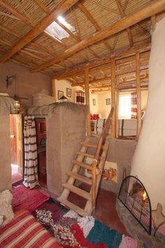 a living area with stairs and rugs on the floor