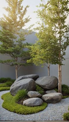 a rock and grass garden with trees in the background