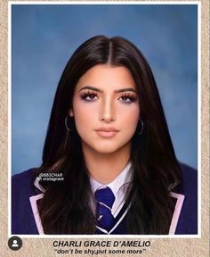 a woman with long dark hair wearing a blue tie