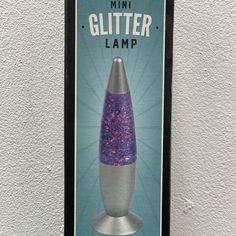 an advertisement for a mini glitter lamp hanging on the wall