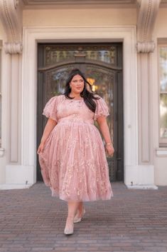 Living In A Pink World Indulge in the sugary bliss of the Eloise Dress - a dreamy holiday masterpiece in soft pink. Featuring delicate floral detailing and shimmering sparkle embellishments, this dress exudes feminine charm. Whether you're dancing under twinkling lights or attending a holiday party, this dress promises to make you feel enchanting. Square neckline Tulle layered flutter sleeve Fitted waistline Back zipper In between sizes, size down (if smaller chested) Model Details Content + Car Feminine Pink Dress For Festive Occasions, Feminine Pink Tea Length Dress, Feminine Pink Festive Dress, Fitted Feminine Dresses For Festive Occasions, Feminine Fitted Dress For Festive Occasions, Playful Pink Dress With Flutter Sleeves, Pink Flutter Sleeve Playtime Dress, Pink Feminine Tulle Midi Dress, Jessakae Dress