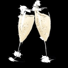 two champagne flutes are toasting with bubbles